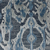 A handmade rug sample with an abstract ikat-style pattern in blue, navy, gray, and off-white.
