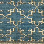 Close-up of a blue and beige ornate trellis patterned rug