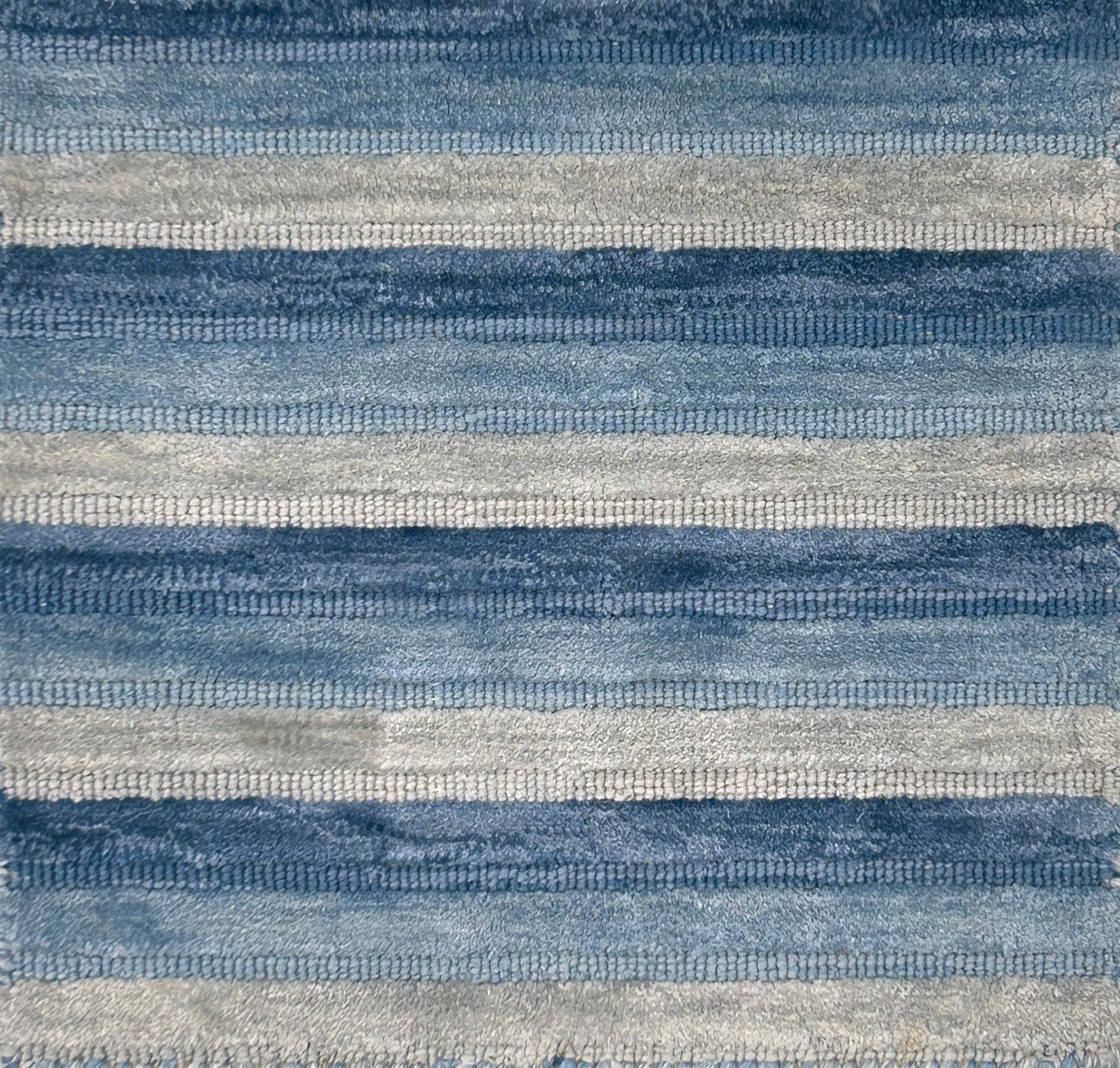 Textured blue and gray striped handknotted rug