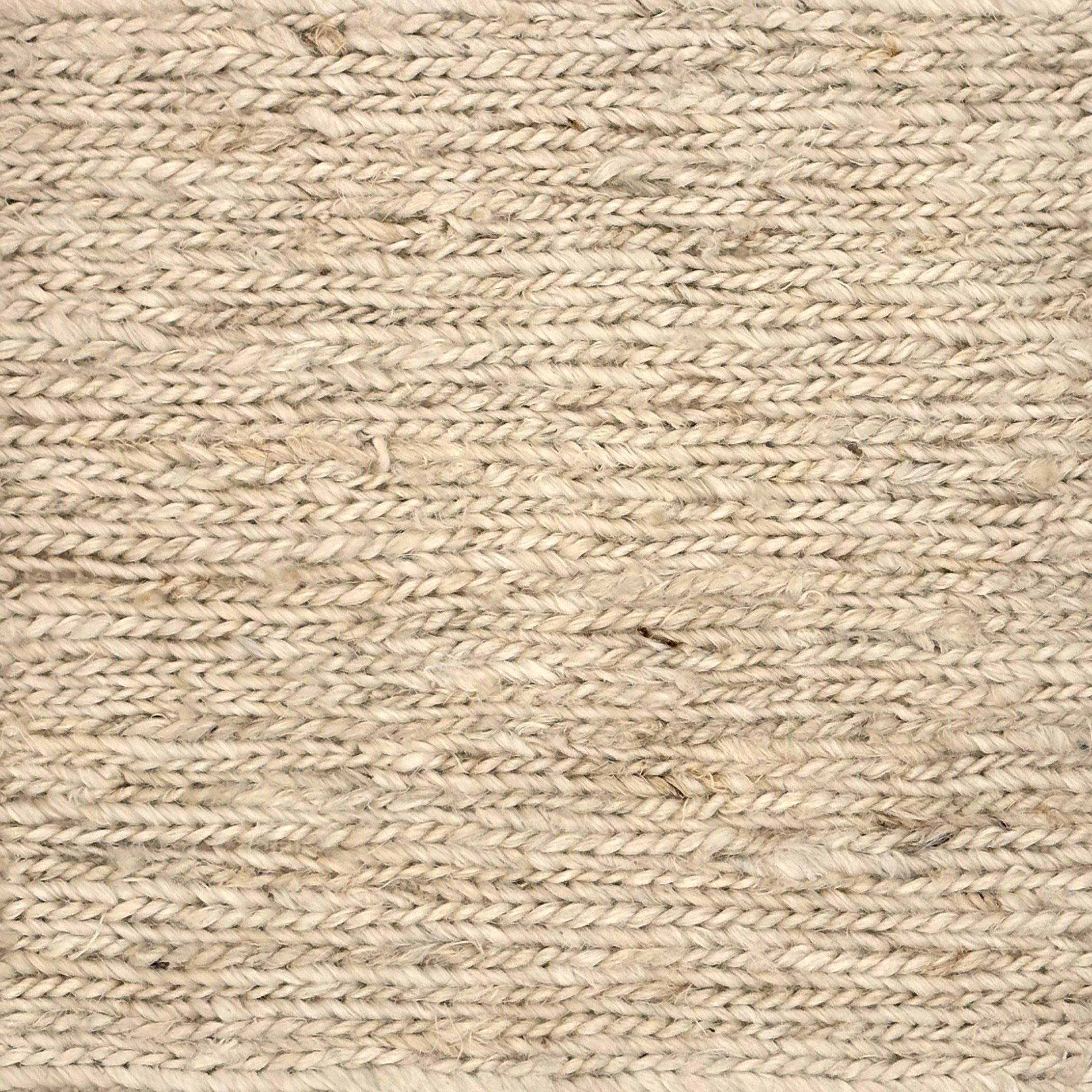 Close up of a rug in a sumak weave in cream