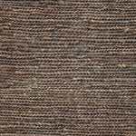 Close up of a rug in a sumak weave in brown-grey
