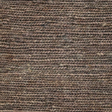 Close up of a rug in a sumak weave in brown-grey