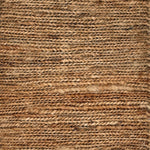 Close up of a rug in a sumak weave in brown