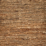 Close up of a rug in a sumak weave in brown