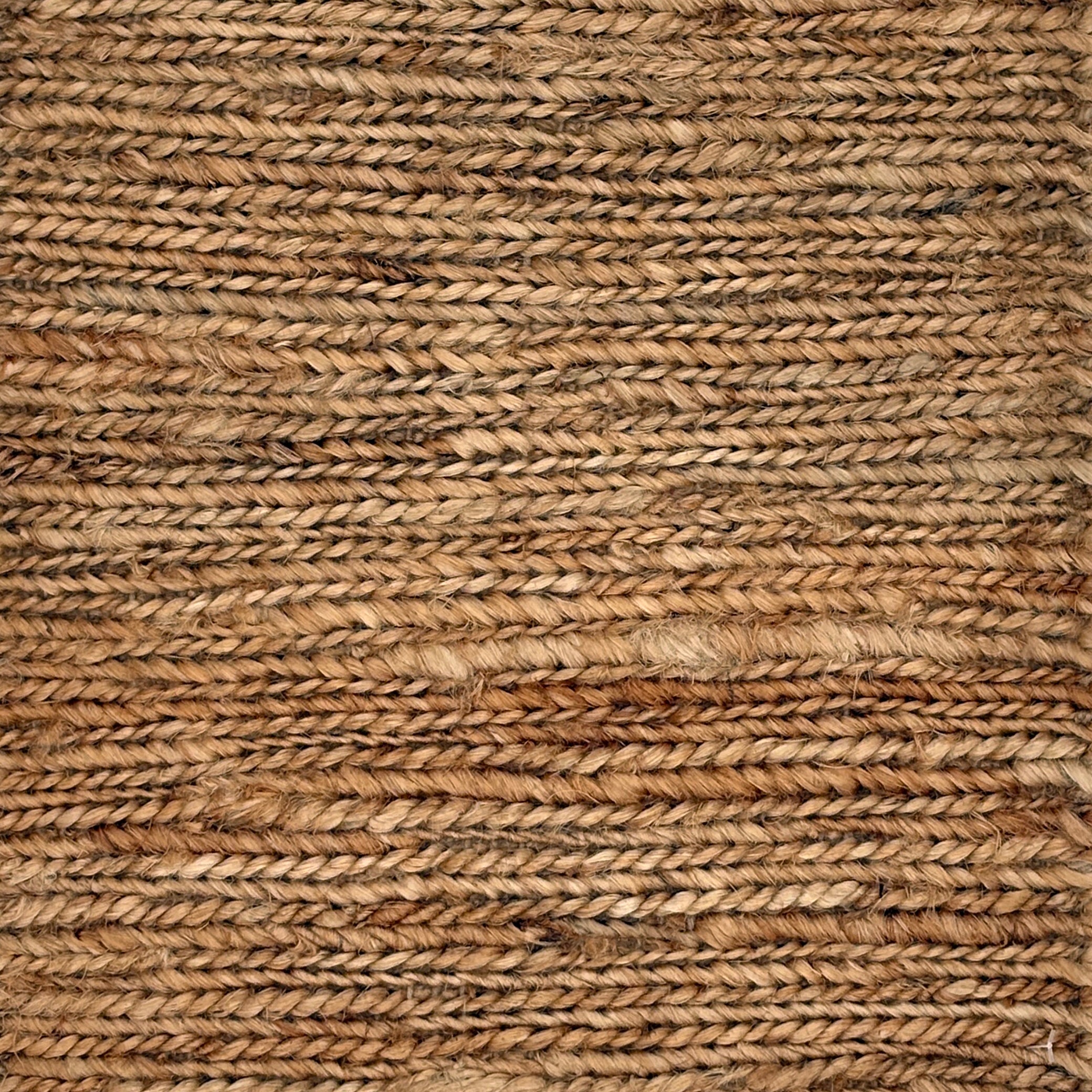 Close up of a rug in a sumak weave in brown