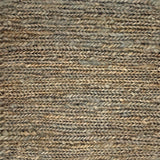 Close up of a rug in a sumak weave in green-brown