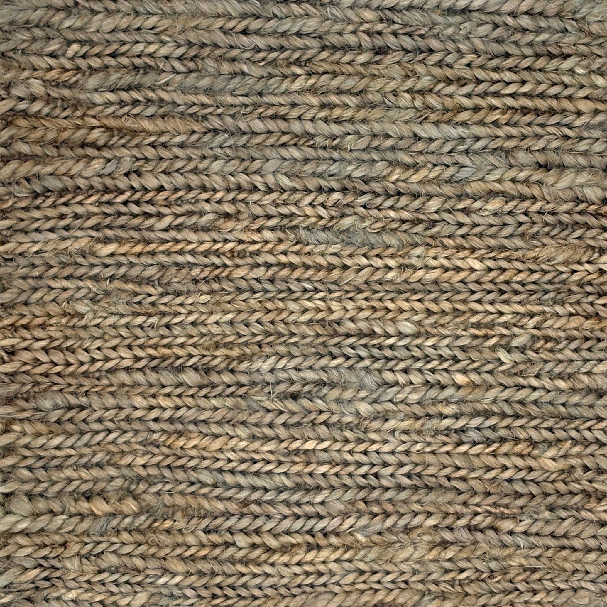 Close up of a rug in a sumak weave in green-brown