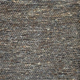 Close up of a rug in a sumak weave in slate grey. 