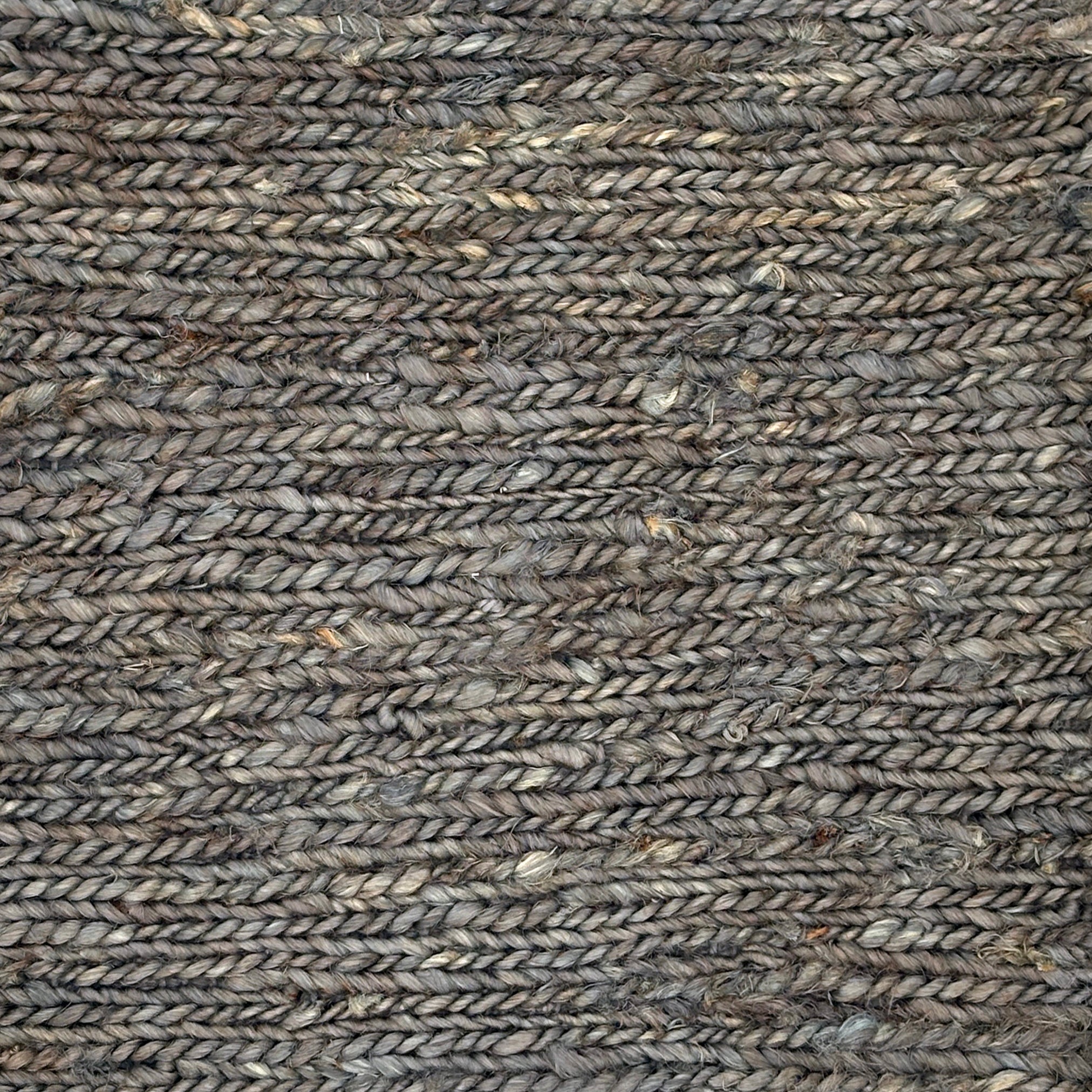 Close up of a rug in a sumak weave in slate grey. 