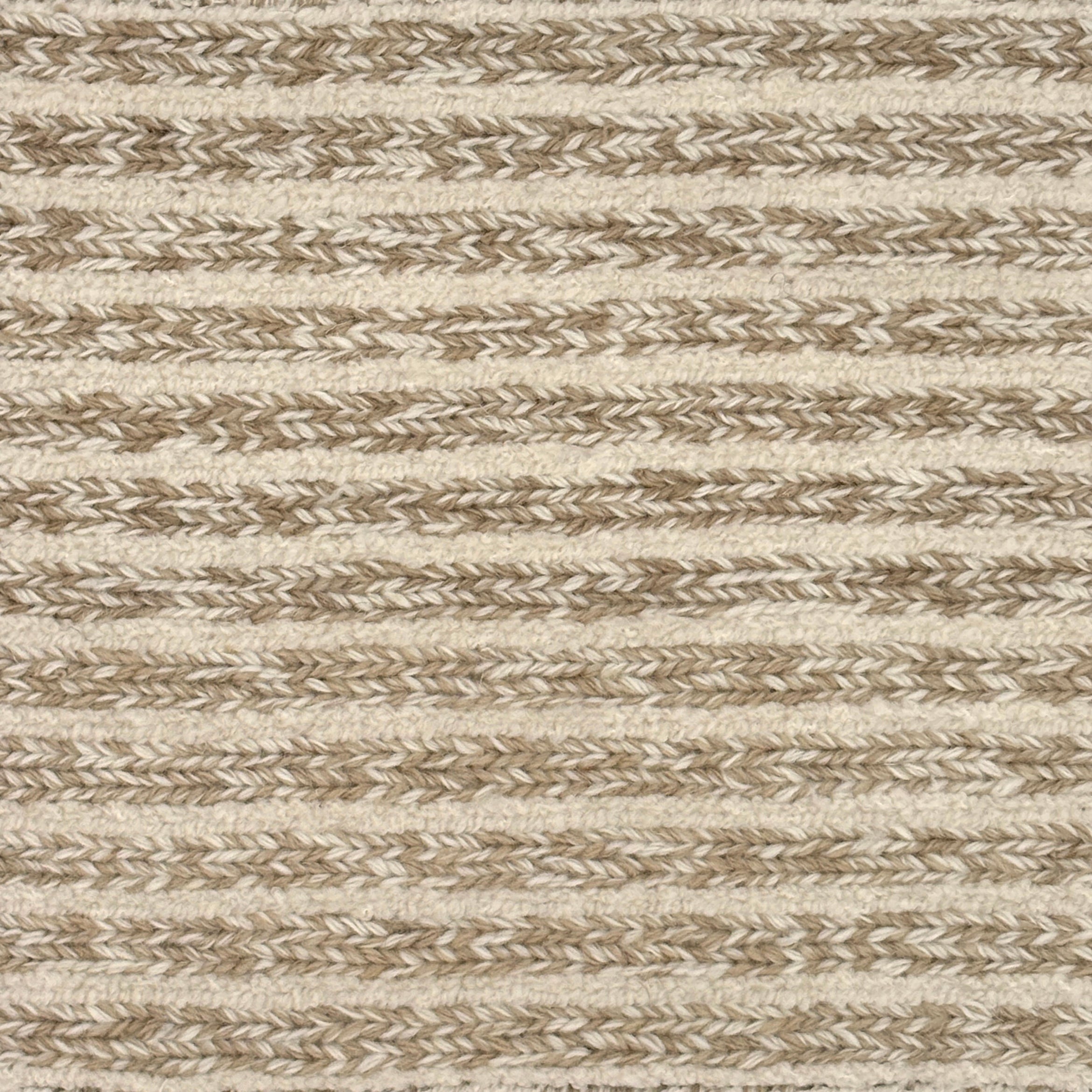 Close up of a handwoven rug in textural sumak weave with cream and taupe stripes.