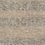 Close up of a handwoven rug in textural sumak weave with grey and beige stripes. 