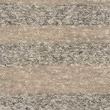 Close up of a handwoven rug in textural sumak weave with grey and beige stripes. 