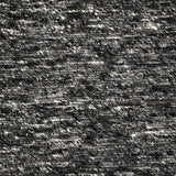 Close up of a handwoven rug in textural sumak weave with black and white mixed yarn.