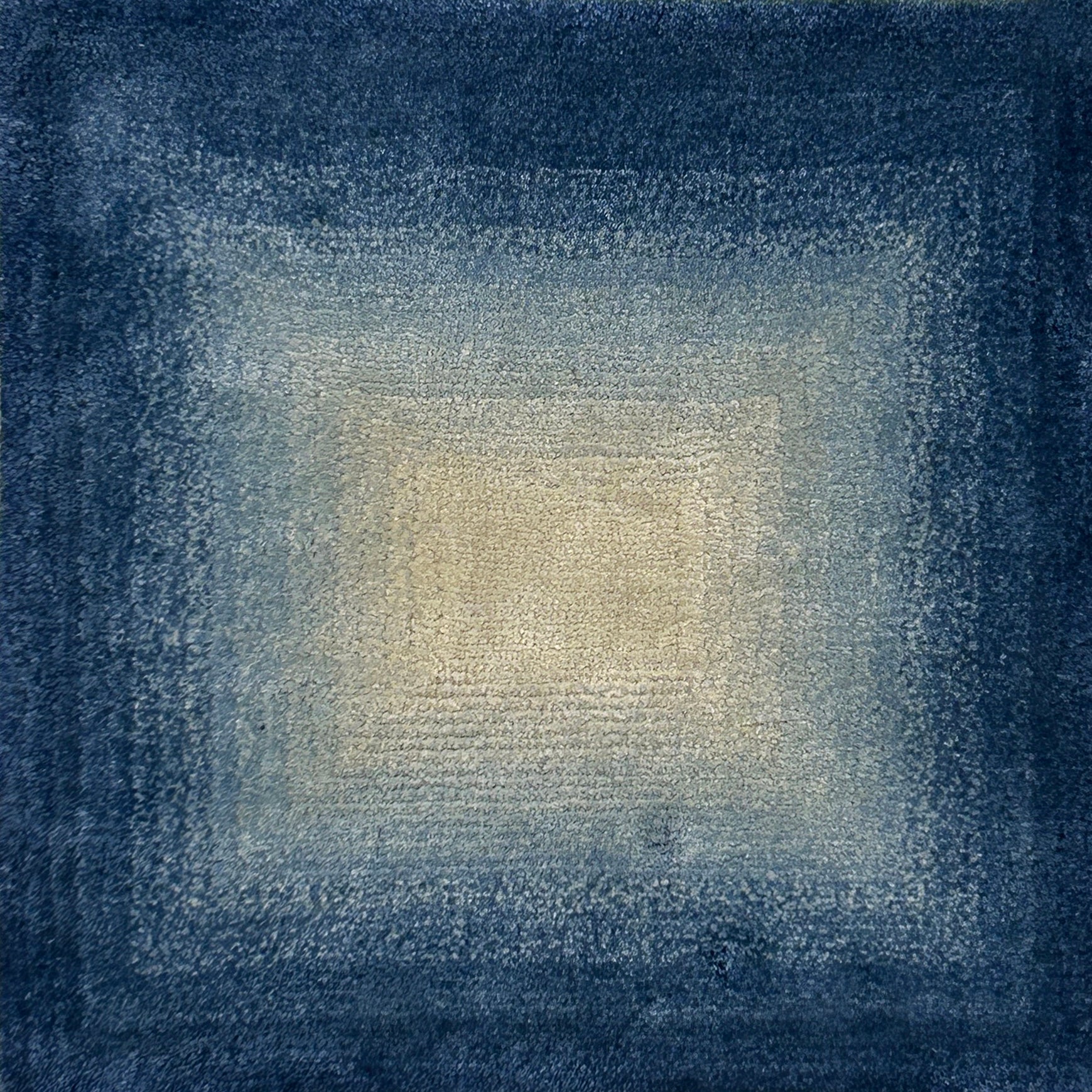 Textured blue and beige square ombré pattern