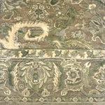 Handknotted rug with ornate botanical pattern in shades of light green. 