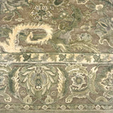 Handknotted rug with ornate botanical pattern in shades of light green. 
