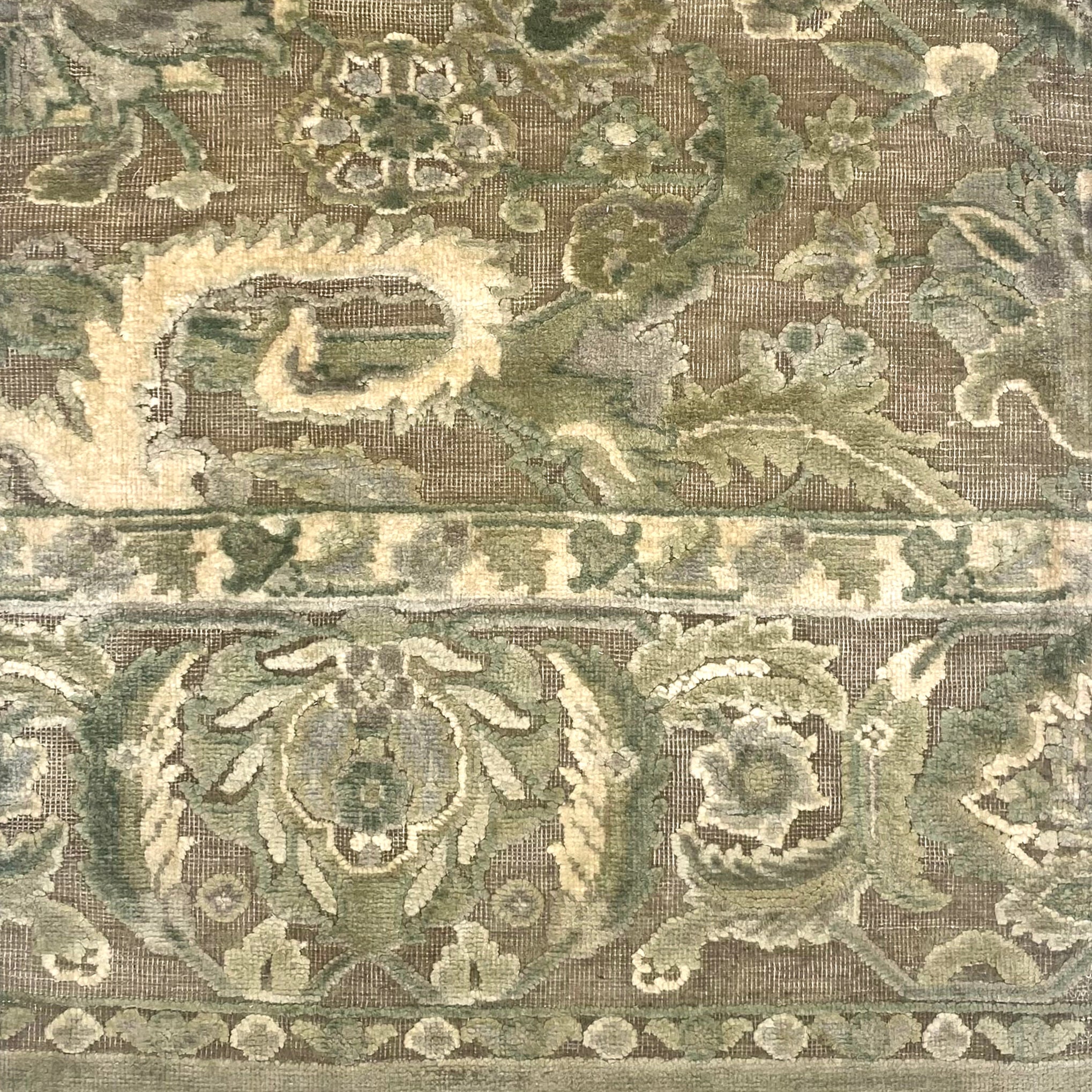 Handknotted rug with ornate botanical pattern in shades of light green. 