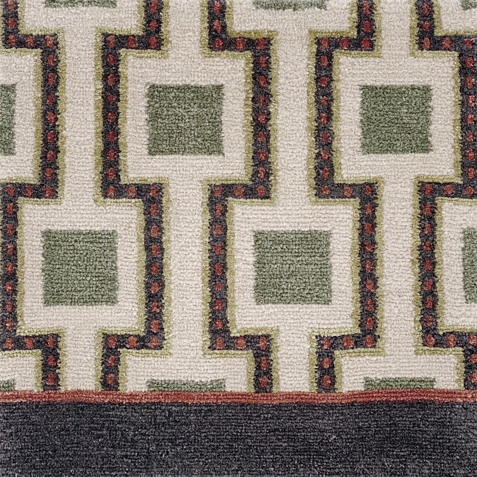 Close-up of a geometric patterned rug with squares and angled lines.