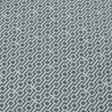 Detail of a wallpaper panel in a geometric grid print in shades of green, blue and gray.
