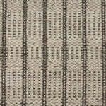 Handwoven rug detail in a stripe design in cream and brown