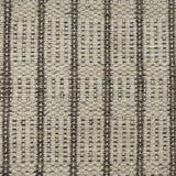 Handwoven rug detail in a stripe design in cream and brown