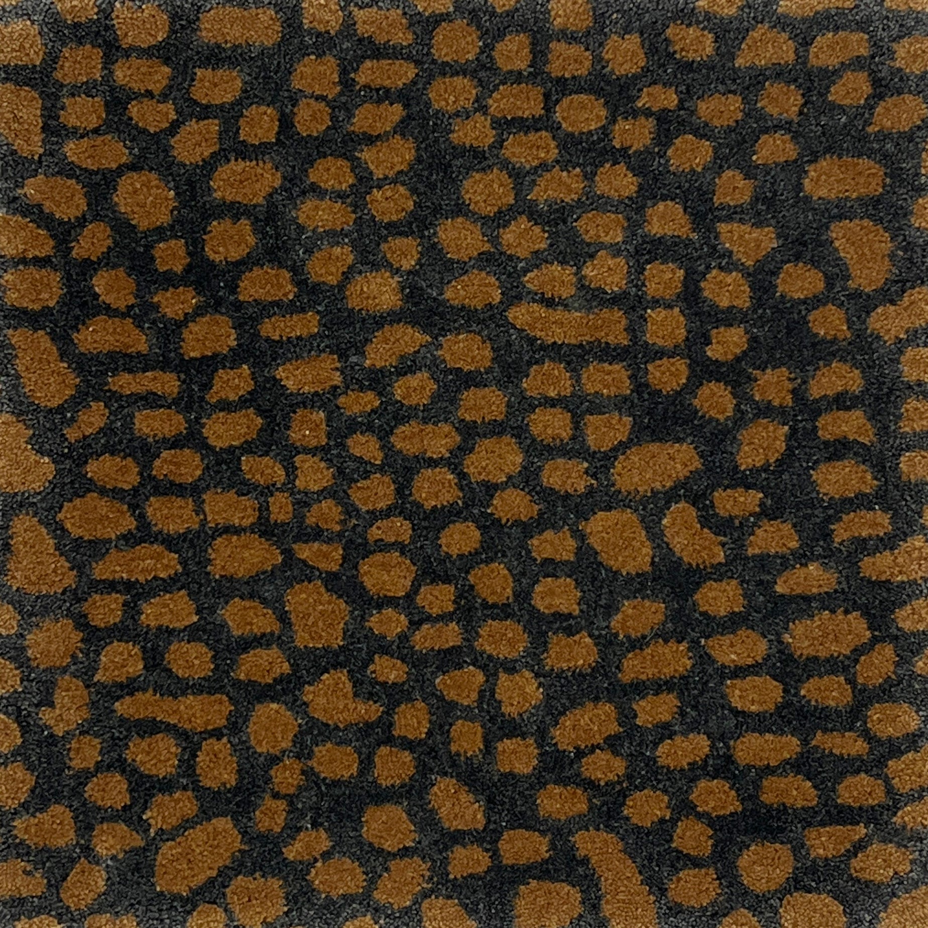 Handknotted rug with abstract animal motif in grey and tan.