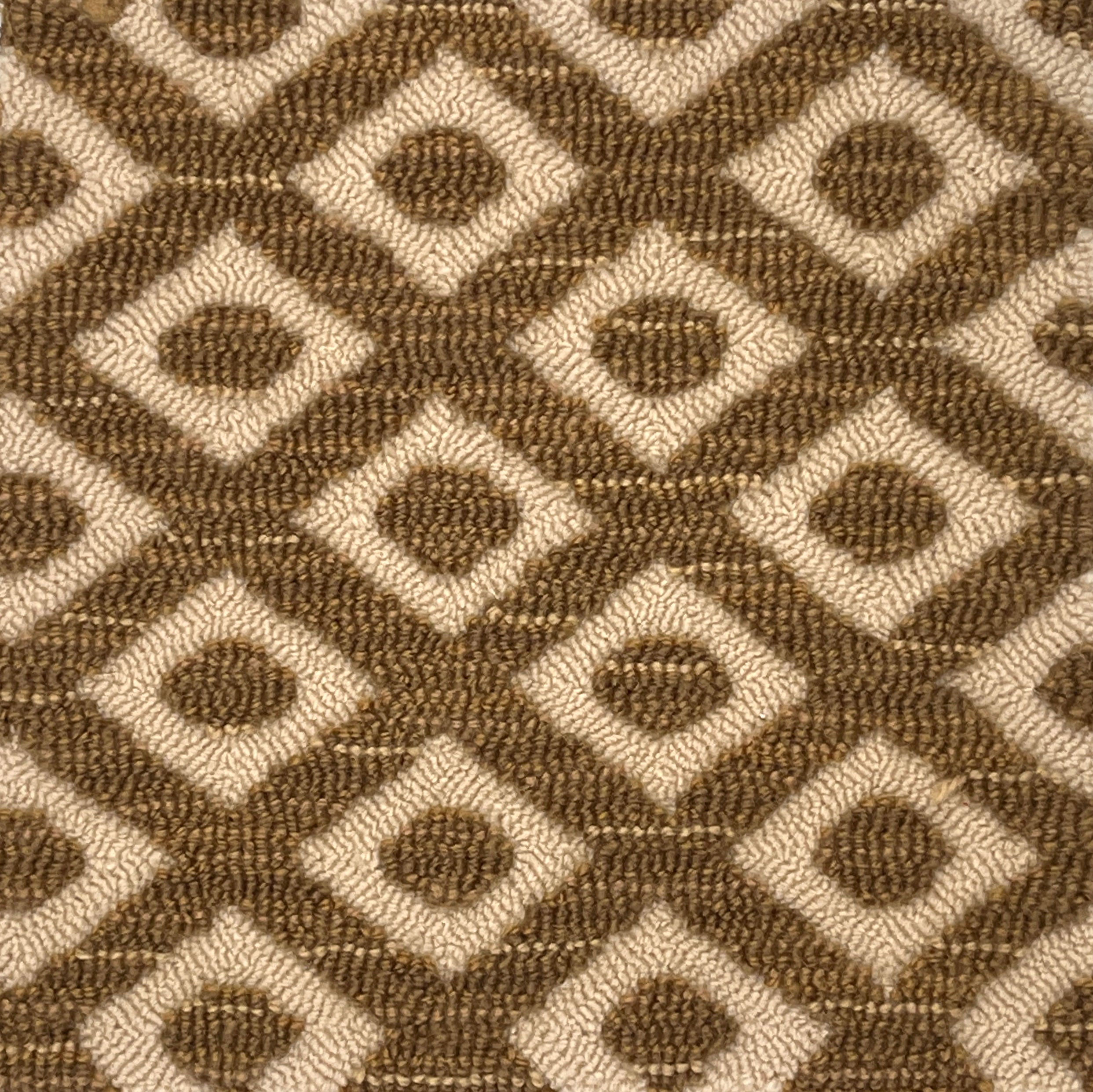 Close-up of a brown and beige geometric patterned rug.