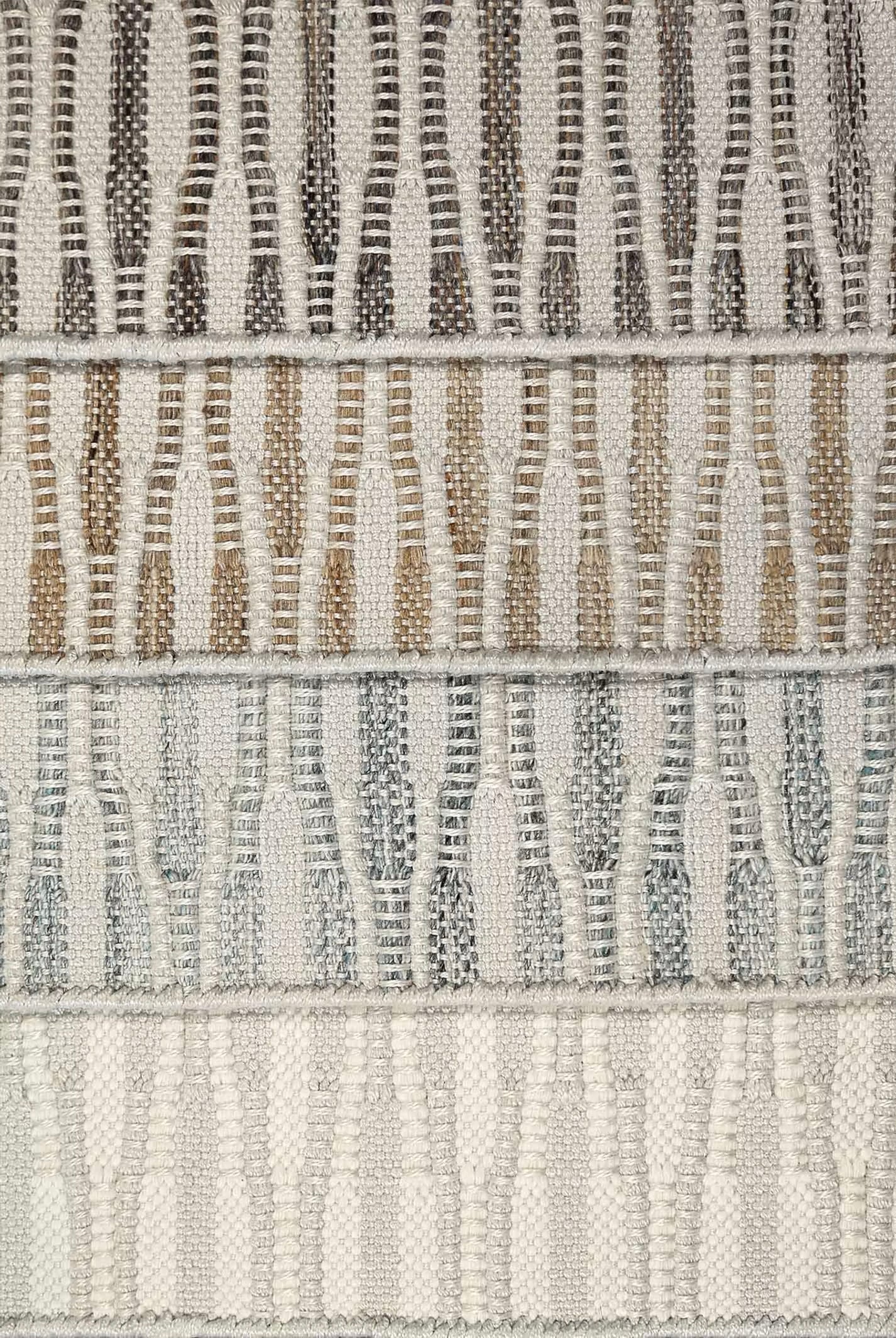 Stack of broadloom carpet samples in a flatwoven wavy stripes. 