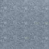 printed linen fabric in a dotted leaf pattern in white on a dusty blue field.
