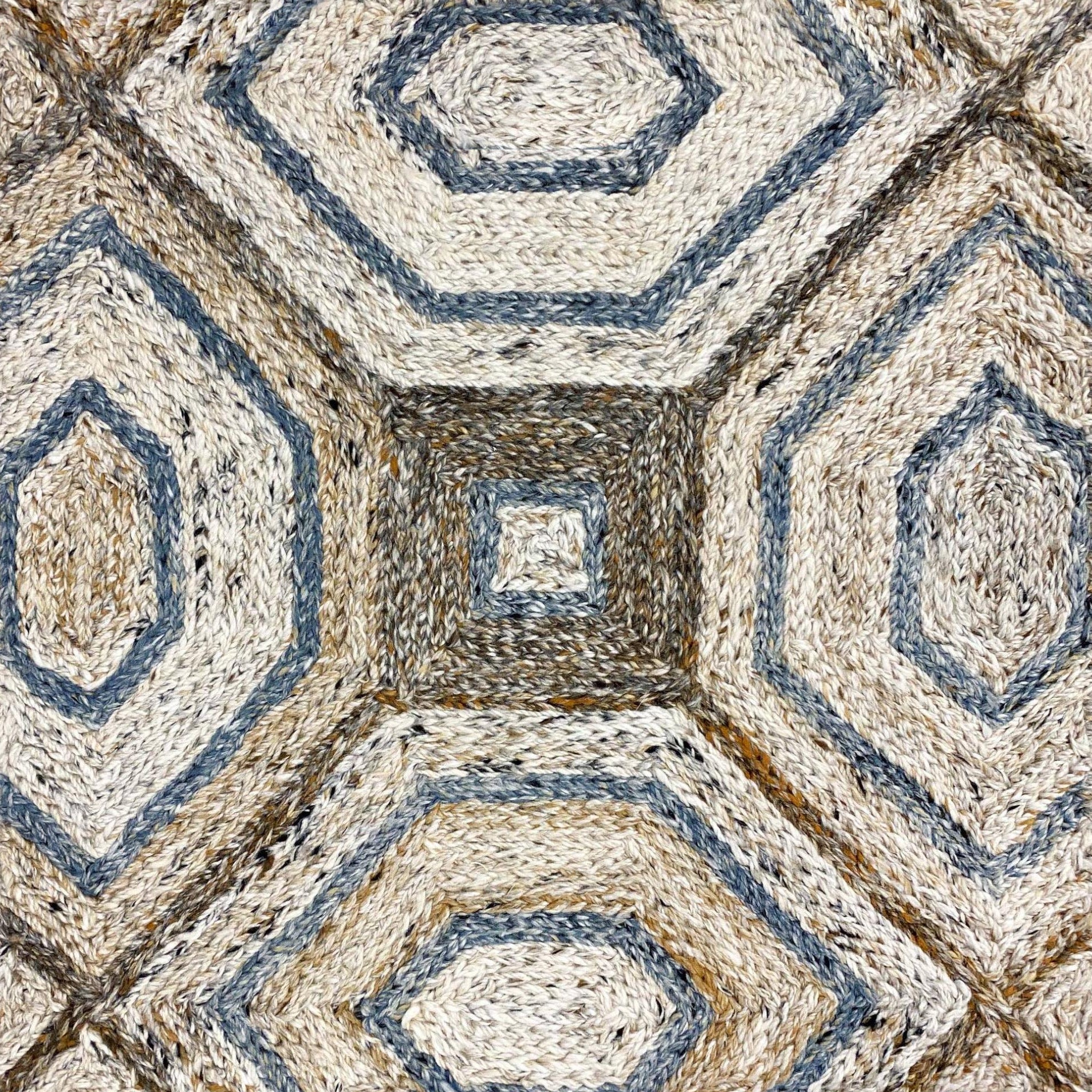 Geometric patterned rug with hexagonal and square shapes in brown and blue tones.
