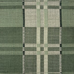 Handwoven rug in a large scale plaid in shades of green and white. 