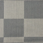 Handwoven rug in a large scale grey and ivory checkerboard pattern. 