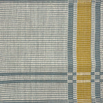 Handwoven rug in a large scale plaid in shades of cream, teal and yellow.