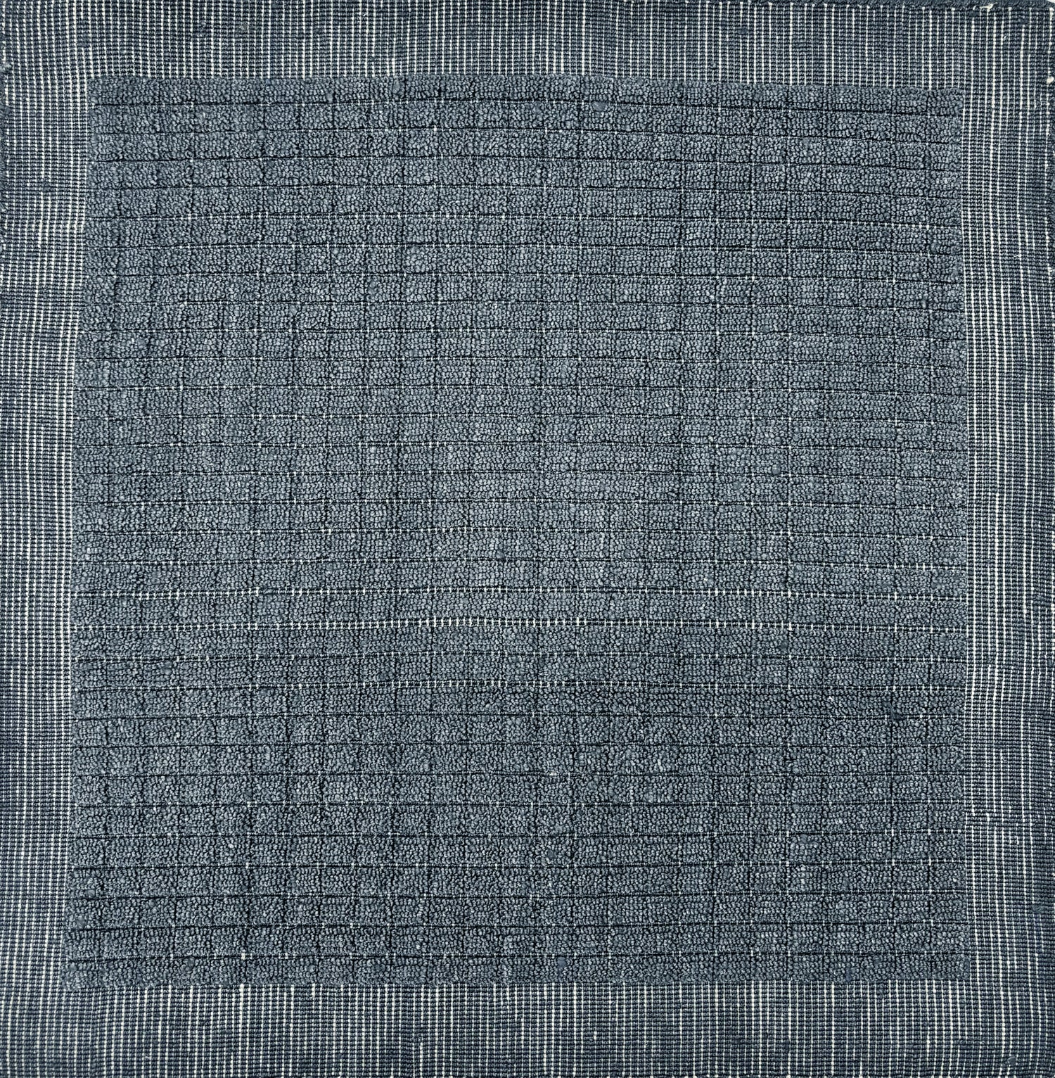 Handknotted rug sample with a tonal steel blue gridded motif.