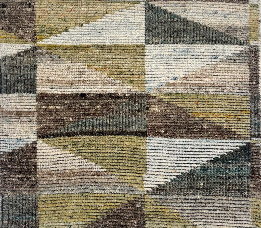 Handknotted rug sample in a diamond harlequin in green, aqua, and charcoal. 