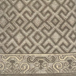 Handknotted rug sample in an old world lattice design with a decorative border in shades of taupe. 