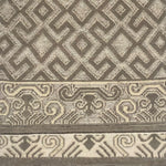 Handknotted rug sample in an old world lattice design with a decorative border in shades of taupe. 