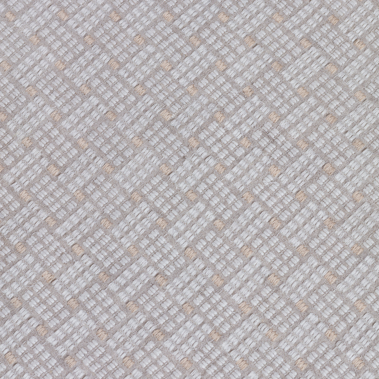 Close up of embroidered fabric with a basketweave design in cream on a beige field. 