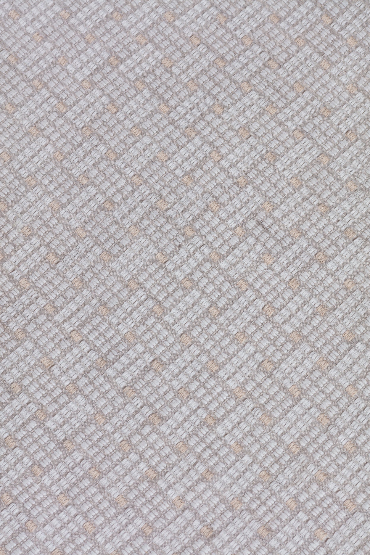 Close up of embroidered fabric with a basketweave design in cream on a beige field. 