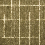 Textured carpet with a checkered pattern in olive green and beige tones.