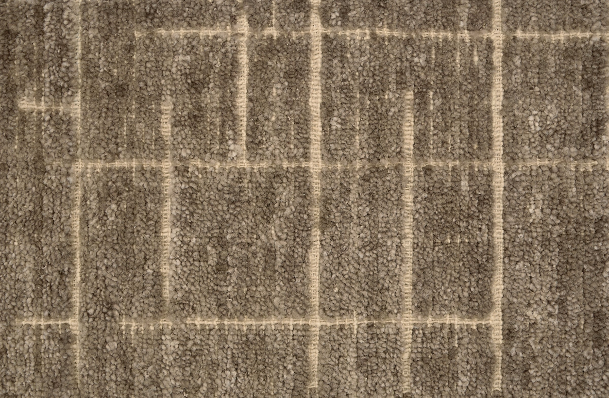 Textured carpet with a checkered pattern in taupe and beige tones.