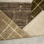 Close-up of textured carpet samples in brown, beige, and gray.