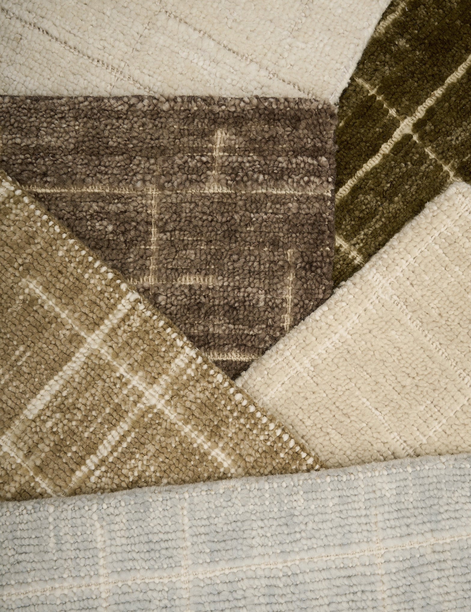 Close-up of textured carpet samples in brown, beige, and gray.
