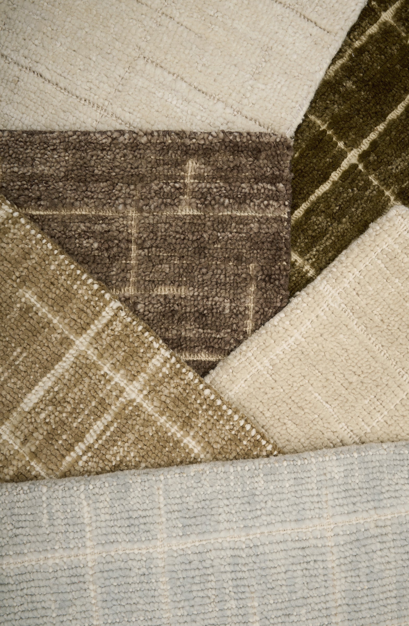 Close-up of textured carpet samples in brown, beige, and gray.