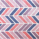 Detail of fabric in a geometric herringbone print in coral, purple and navy on a white field.