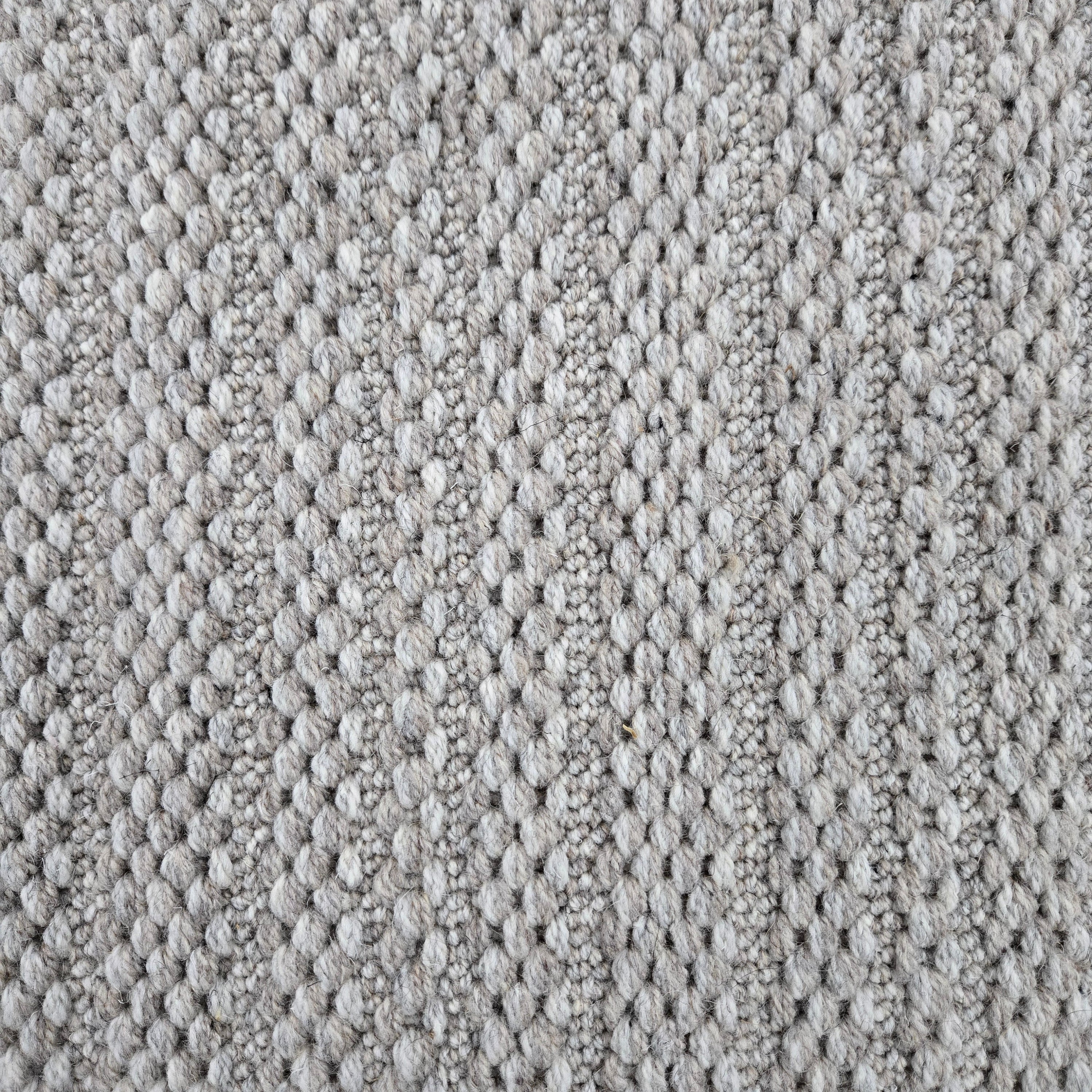 Broadloom carpet in a textured stripe in silver-y taupe. 