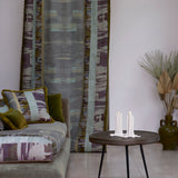 Living room with a couch in watercolor print, and a curtain panel in a matching design.