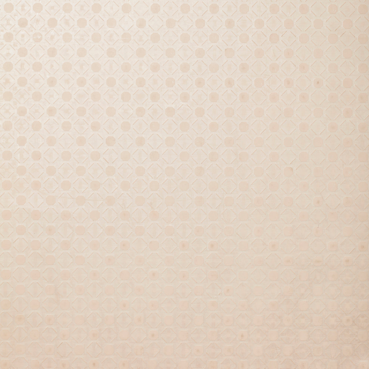 Detail of wallpaper in a honeycomb grid print in pastel pink on a cream field.
