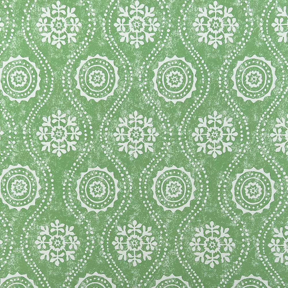 Detail of wallpaper in a playful floral stripe in cream on a green field.
