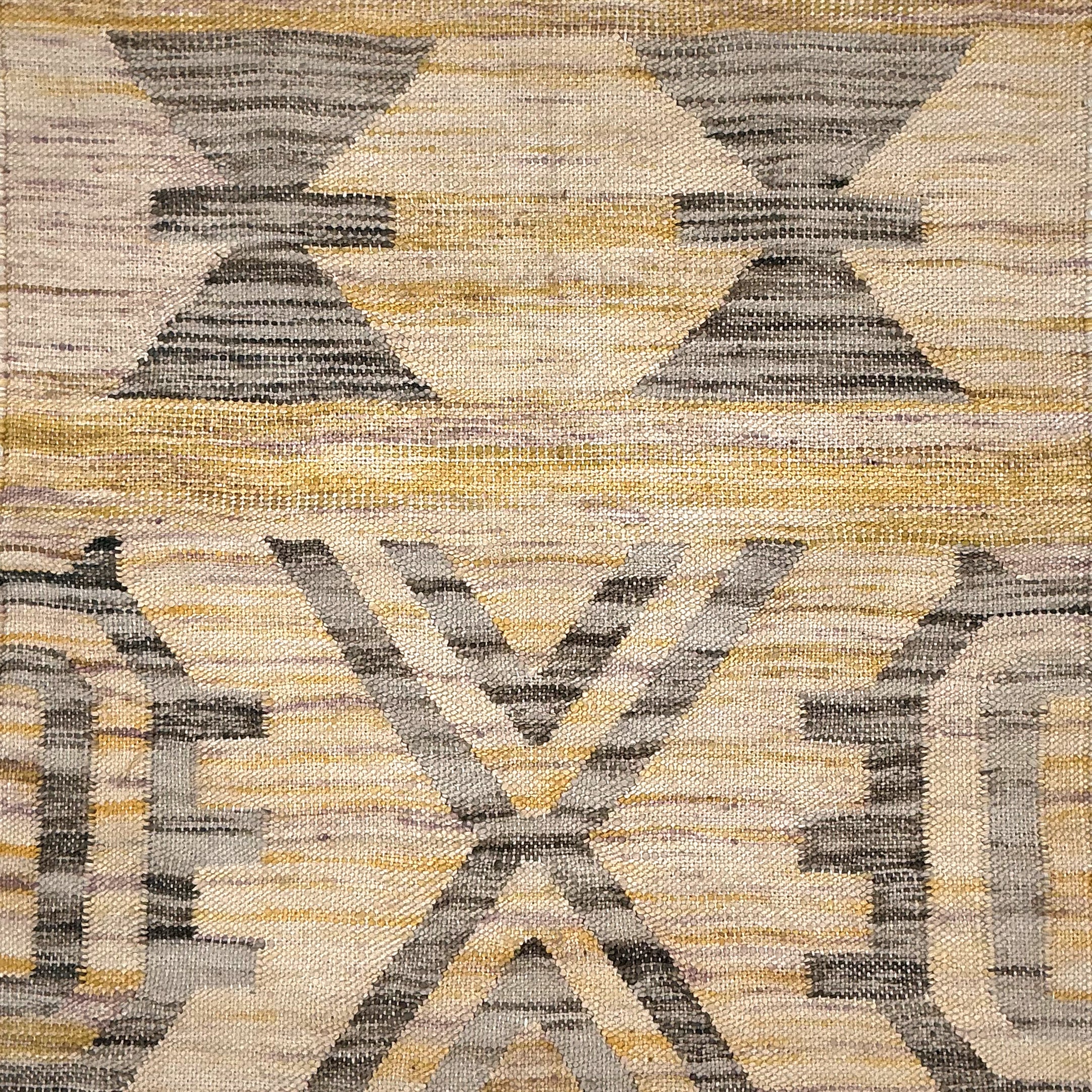 Patterned rug with geometric design in beige, brown, and gray colors